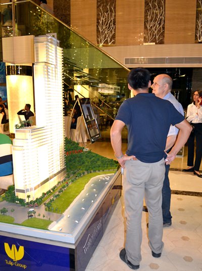 Party guests view a scale model of the project.