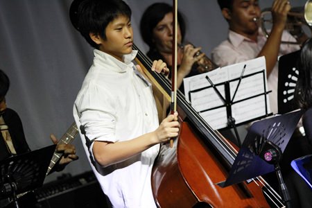 A Year 10 student helps out the band with his cello.