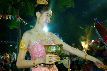 A beautiful angel showers flowers down to humans while visiting earth.