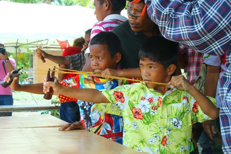 Ready, aim, fire!  Children enjoy testing their aim with the slingshots, an ancient local game.