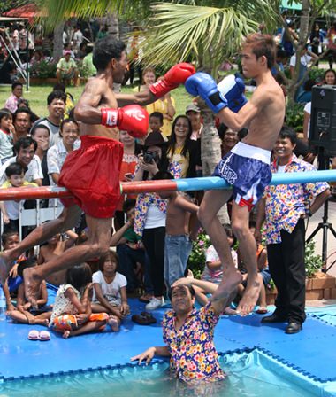 Winner stays up, loser falls into the water.  Great laughs for the audience.