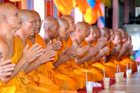 Monks pray before dining.