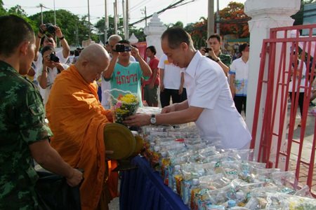 Chonburi Governor Khomsan Ekachai presents alms to monks on Visakha Bucha Day at Chonburi Provincial Hall.