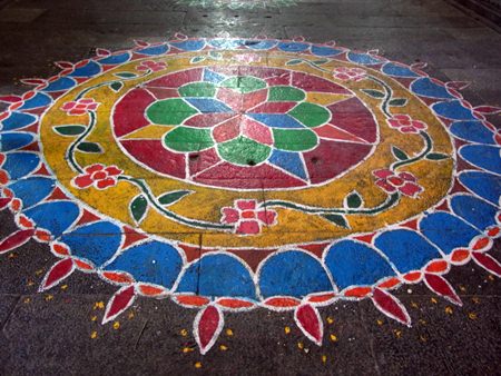Kolam, a form of painting that is drawn by using rice powder chalk, chalk powder, white rock powder and often using naturally synthetically colored powders.