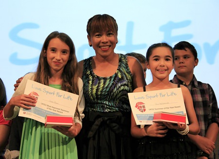 PE Teacher Miss Meena hands out certificates to two more deserving students.