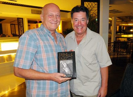 Past President Jan Abbink (left) receives a signed copy of “The Perfect Pair” from author David C Holroyd (right).