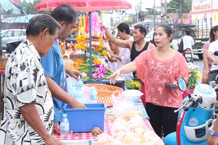 Local people purchase food to donate to the monks at Wat Suttawas.