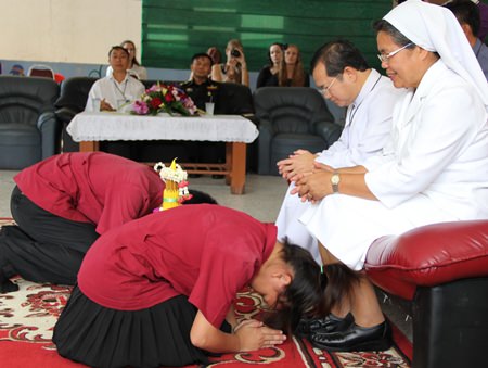 The vocational students pay respect to Father Michael and Sister Pavinee.