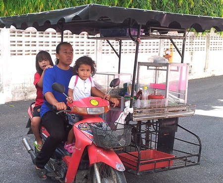 Duangjai, Siripatrara and her 4-year-old daughter sit on the bike Jesters gave her with the modified side car.