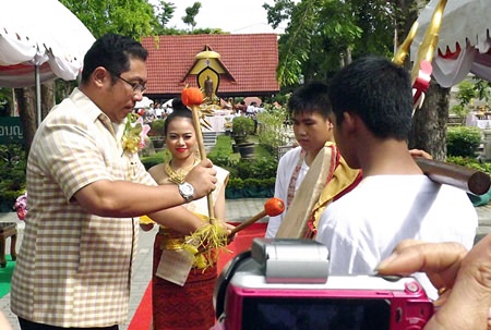 Sonthaya Kunplome, former minster of culture, plays the Thai war drum to signal the opening of the event.