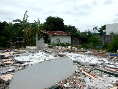  Only one home remains amongst the rubble.