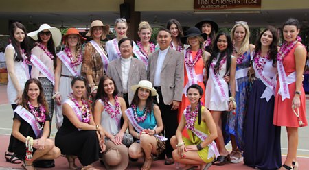 Father Michael and Father Peter, from the Father Ray Foundation, pose with the beauty queens.