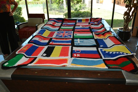 Lesley knitted and crocheted a bed cover made up of all the flags of all the countries that they passed through. Most of the flags were made in the country that the flag represents.