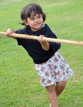 3-year-old Baan does her best in the tug-o-war competition - and does it without losing her cute smile.