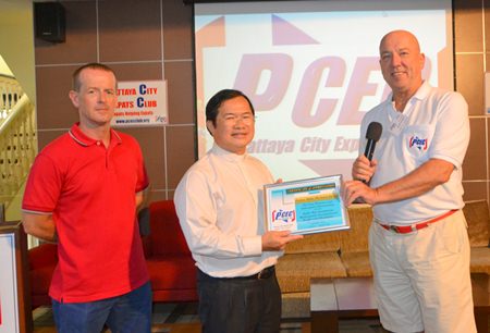 PCEC Chairman Roy Albiston presents a certificate of appreciation for the presentation about the Father Ray Foundation to Father Mike as Foundation staff member Derek Franklin looks on.
