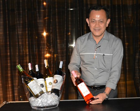 Teera Weerawan, National Sales Manager of Independent Wine & Spirit, displays a bottle of wine.