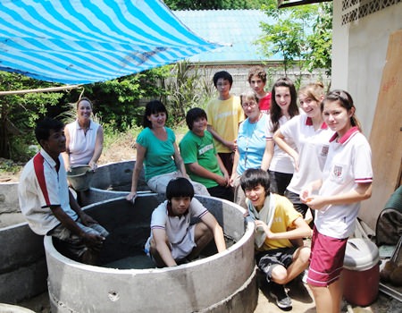 Students from Regents International School with the WWM team working to build fish tanks to help set up small businesses for families with handicapped members.