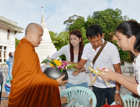 The Theerarak family makes merit at Wat Chong Lom in Naklua.