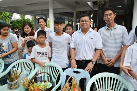 Deputy Mayor Verawat Khakhay and his family make merit at Wat Chong Lom in Naklua.