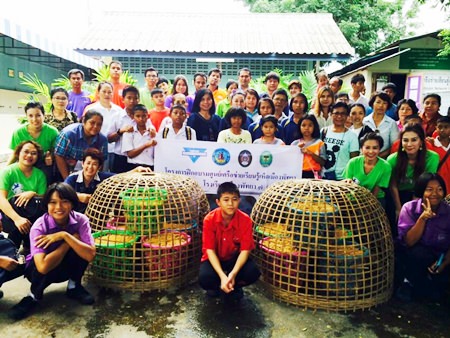 YWCA Chairwoman Praichit Jetpai (standing, 3rd left) along with YWCA members and guests teach students and teachers at Pattaya School No. 7 how to grow mushrooms.
