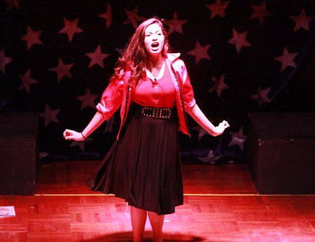 Betty Rizzo belts out a song as part of GIS’s Grease production.