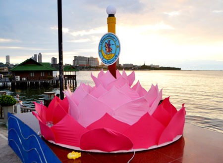 The sun sets behind a giant krathong on Beach Road Pattaya.