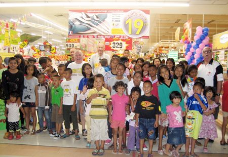 The children and sponsors pose for a group photo before letting the kids loose on their shopping trip inside Big C.