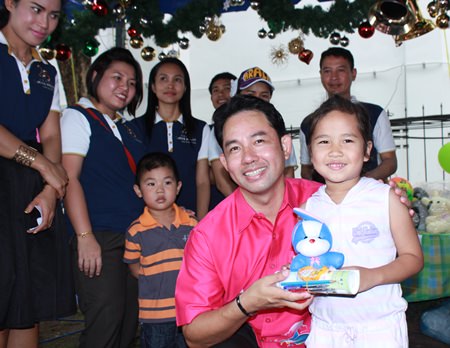 Mayor Itthiphol Kunplome is on hand to hand out presents to children.