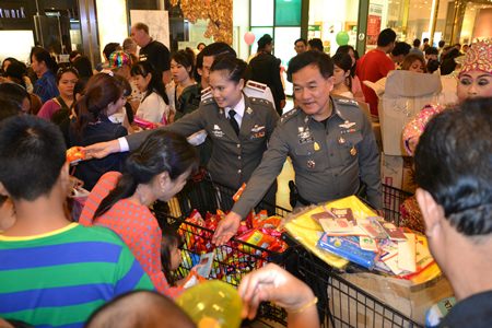 Pol. Col. Supathee Bungkhrong, Deputy Commander of Chonburi Provincial Police, Acting Superintendent of Pattaya Police Station, leads a team of police officers to bring presents, sweets and toys to give children at Central Festival Pattaya Beach.