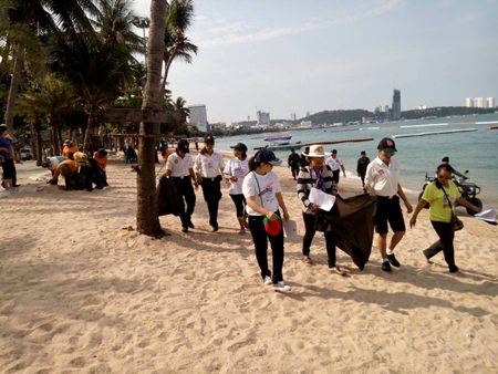 Police volunteers and friends grab garbage bags and help keep the beach clean.