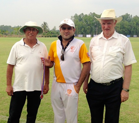 Man of the match Salman Khan (centre) with umpires David Lusha and Roger Lucas.