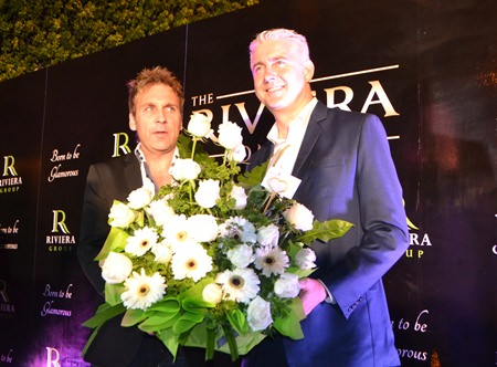Brendan Daly (right), General Manager of the Amari Pattaya presents flowers and congratulates Winston Gale (left) of the Riviera Group on the grand opening of the new showroom.