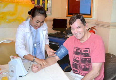 PCEC Member Bob Erends appears to be enjoying having his blood pressure checked by the nurse from Bangkok Hospital Pattaya. The hospital usually sends a nurse along with the hospital’s speaker to give free blood pressure checks for members and guests.