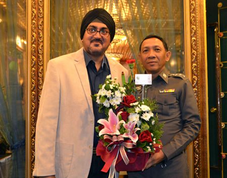 Deputy Commander of Trat Provincial Police, Pol. Col. Sujin Meekajit congratulates Naini Grover.