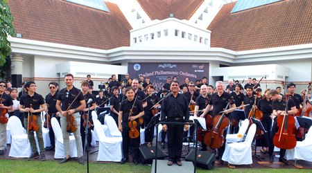 Conductor Lt. Col. Prateep Suphanrojn (centre) poses with the Thailand Philharmonic Orchestra at the Phornprapha Botanic Gardens in Pattaya. 
