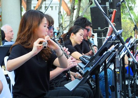 A flautist from the woodwind section performs a solo.