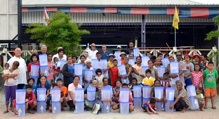 Members of TFi and the Rotary Club Of Eastern Seaboard present portable water filters to some of the most impoverished members of the local community.