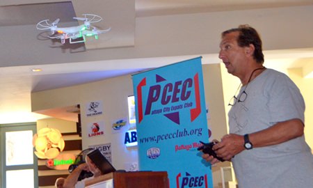 Paul Rosenberg shows his PCEC audience one of the remote-controlled quad-copters he brought with him. He noted that this particular model is manufactured here in Pattaya was not expensive and could be fitted with a camera. With a monitor affixed to the remote control device, it is almost like being on board as you soar through the air.