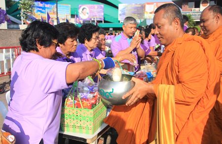Residents of Nongprue take part in the merit making activities, presenting alms to 61 Buddhist monks.