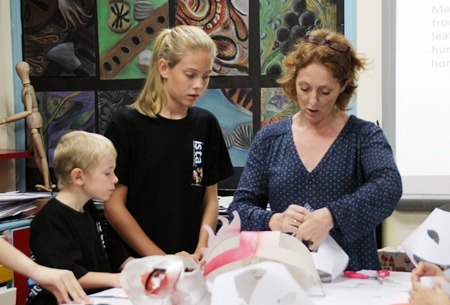 Art teacher Clare Spear leads the mask making workshop.