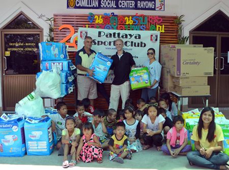 PSC Golf Chairman Mark West, Camillian Volunteer Jimmy Juergen, and PSC Charity Chairperson Noi Emmerson hand over basic necessities for HIV/AIDS patients under the care of Camillian Social Center Rayong.