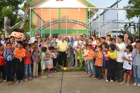 Rotary Phoenix Vice President Stephan Heynert leads the ribbon cutting ceremony to officially present a new playground setup to the Child Protection and Development Center.