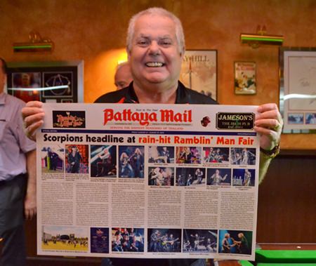 Kim Fletcher the landlord of Jameson’s Irish pub with a souvenir poster of his recent trip to the Ramblin Man festival in the UK.