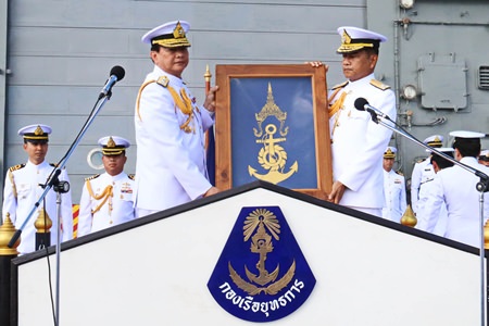 Retiring commander, Adm. Pijan Teeranet (left) passes over the command flag to successor Vice Adm. Narith Prathumsuwan (right) on the deck of the HTMS Naresuan aircraft carrier.