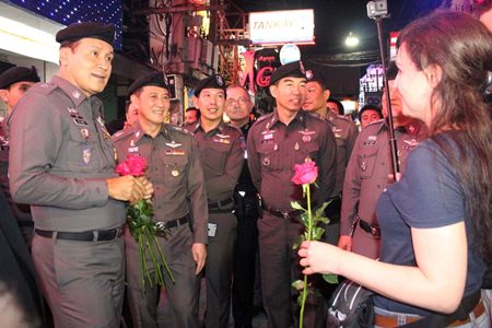 Tourist Police Region 3 deputy commander, Pol. Lt. Gen. Naret Nantachot and Tourist Police officials reach out to Pattaya tourists, offering roses on Walking Street to reassure visitors that helping tourists and preventing crime are top priorities.
