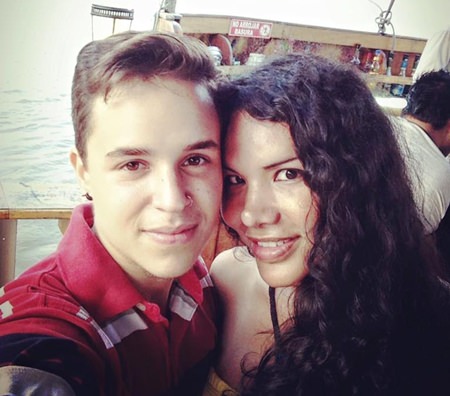 This Nov. 11, 2015 photo courtesy of Fernando Machado shows him, left, taking a selfie with his partner Diane Rodriguez in Guayaquil, Ecuador. (Fernando Machado via AP)