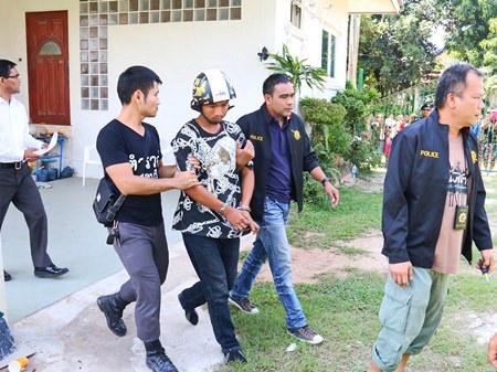 Police take away Tatpong Thamnai to face charges of burglary, murder and necrophilia.