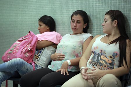 In this Thursday, Feb. 11, 2016 file photo, Daniela Rodriguez, 19, six-weeks pregnant, sits between two other women who are expecting, as they wait for test results after being diagnosed with the Zika virus at the Erasmo Meoz Hospital in Cucuta, Colombia. (AP Photo/Ricardo Mazalan)
