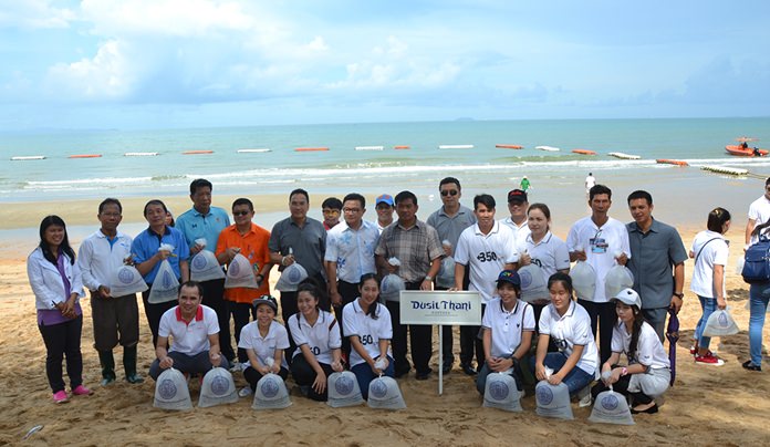 Staff of the Dusit Thani Pattaya Hotel pose for a group photo before releasing their fish.