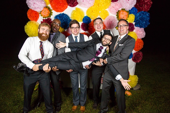 In this Sept. 26, 2015, photo provided by Russell Brammer, groom Marley Jay gets hoisted by, from left, Mark Fairchilds, Guy Anglade, Adam Wishneusky, Jesse Bowline, Nathaniel Poor, after the wedding, in Stone Ridge, N.Y. When Jay and his wife nixed photos for part of their wedding, they decided a photo booth would liven things up. (Russell Brammer/rbphotobooth.com via AP)